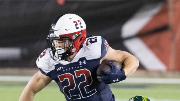 Feb 18, 2023; Houston, TX, USA; Houston Roughnecks running back Max Borghi (22) breaks a tackle by Orlando Guardian linebacker Terrance Smith (8) in the fourth quarter at TDECU Stadium. Mandatory Credit: Thomas Shea-USA TODAY Sports  
